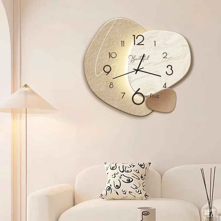 Heart-shaped wall clock on a wall above a sofa with a decorative pillow.
