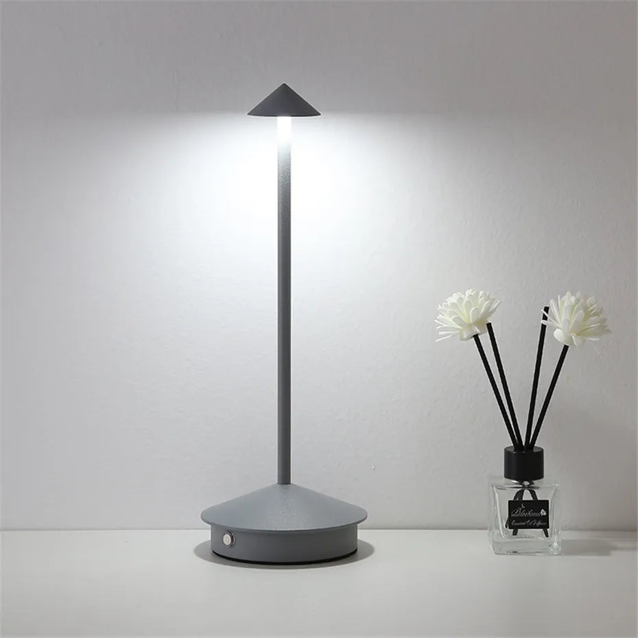 Modern gray floor lamp with a diffuser bottle on a light gray background