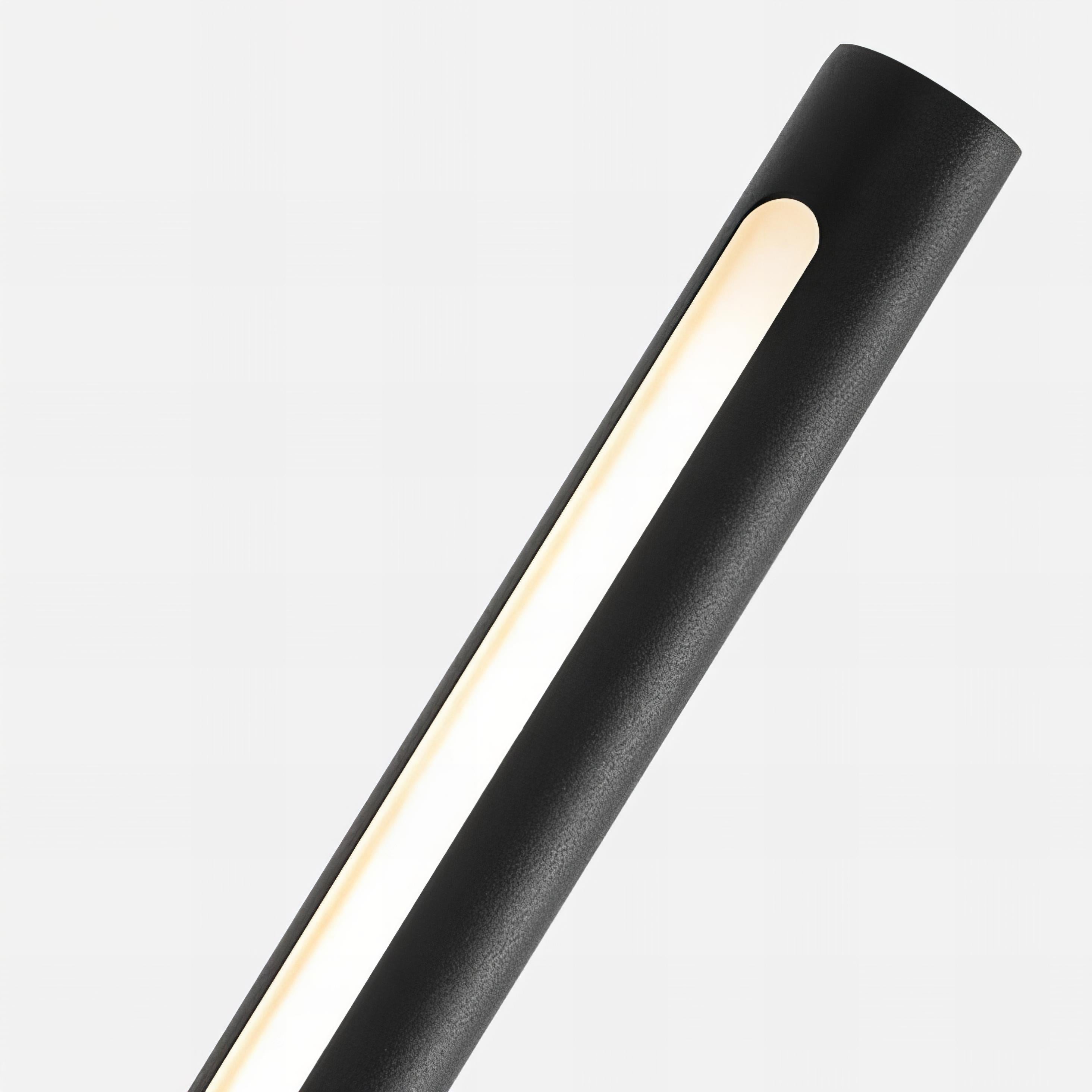 Modern black cylindrical light fixture on a white background