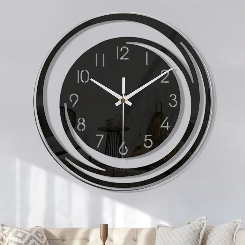 Wall clock with black face and white numbers on a light gray wall.