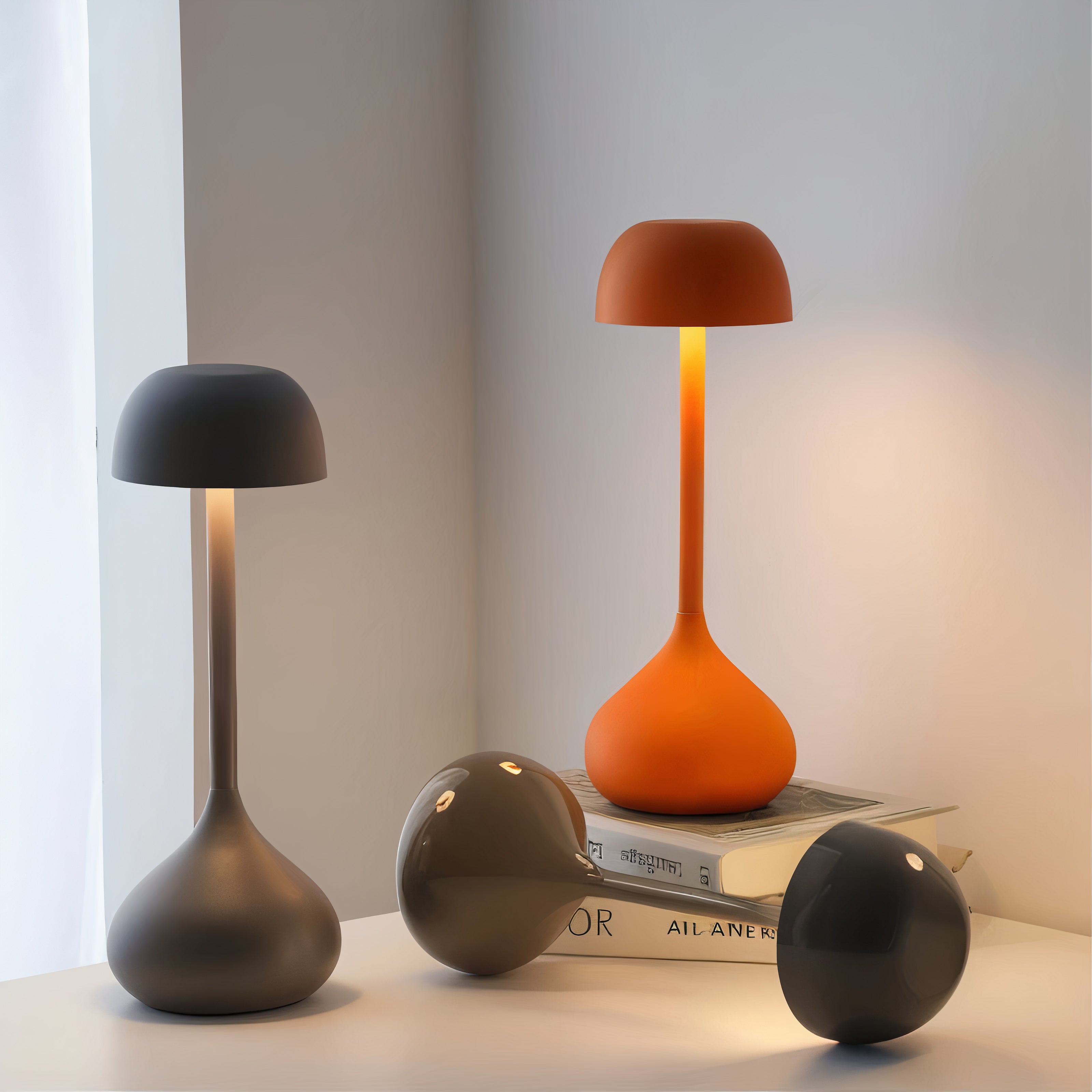 Three table lamps in different colors on a surface with a neutral background
