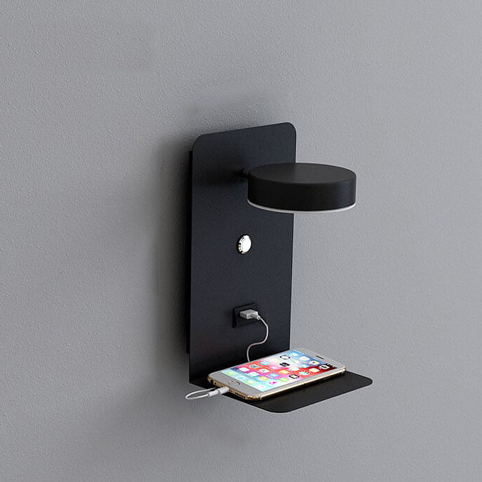 Black wall-mounted charging station with a smartphone on a gray background