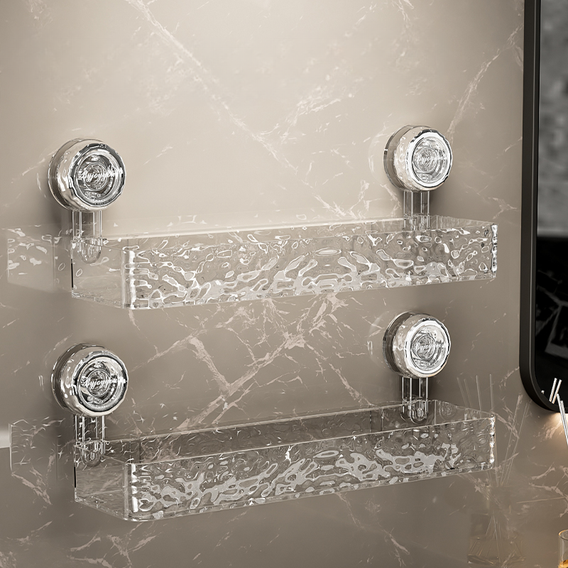 Clear acrylic shelf with chrome brackets on a marble wall.