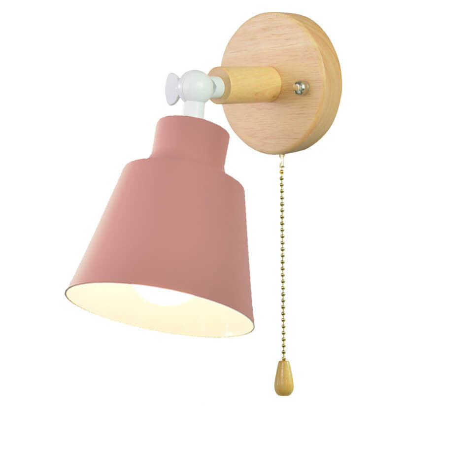 Wall lamp with pink shade and wooden fixture on a white background