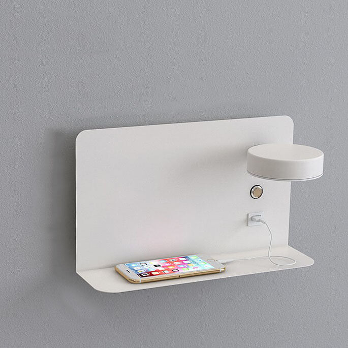 White wall-mounted shelf with a smartphone and small lamp on a gray background