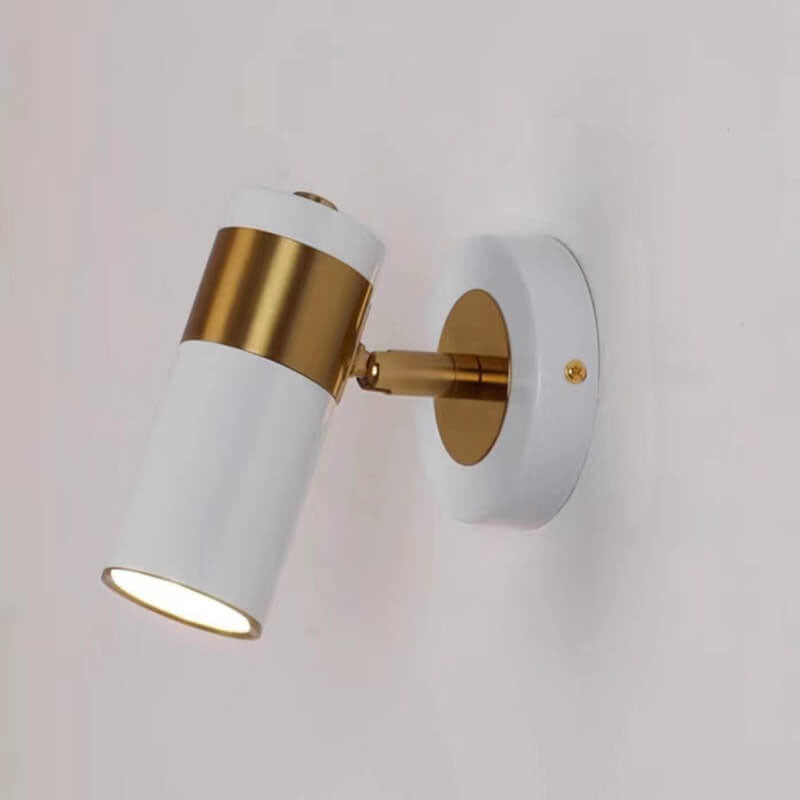Wall-mounted light fixture with white and gold design on a plain background