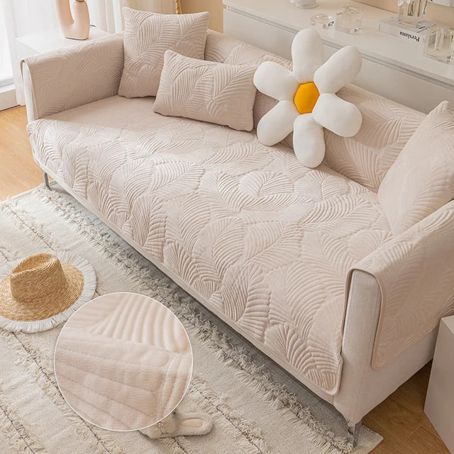 Beige sofa with decorative pillows and a flower-shaped balloon in a living room setting.