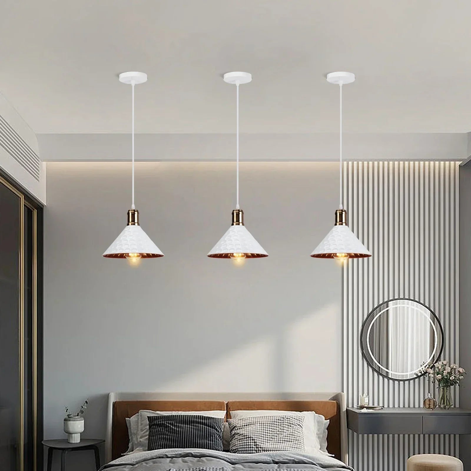 Modern bedroom with three pendant lights, bed, and wall mirror.
