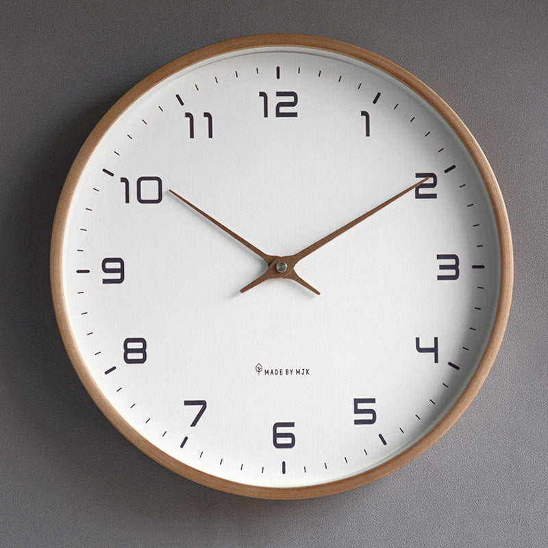 Wall clock with wooden frame and white face on a gray background