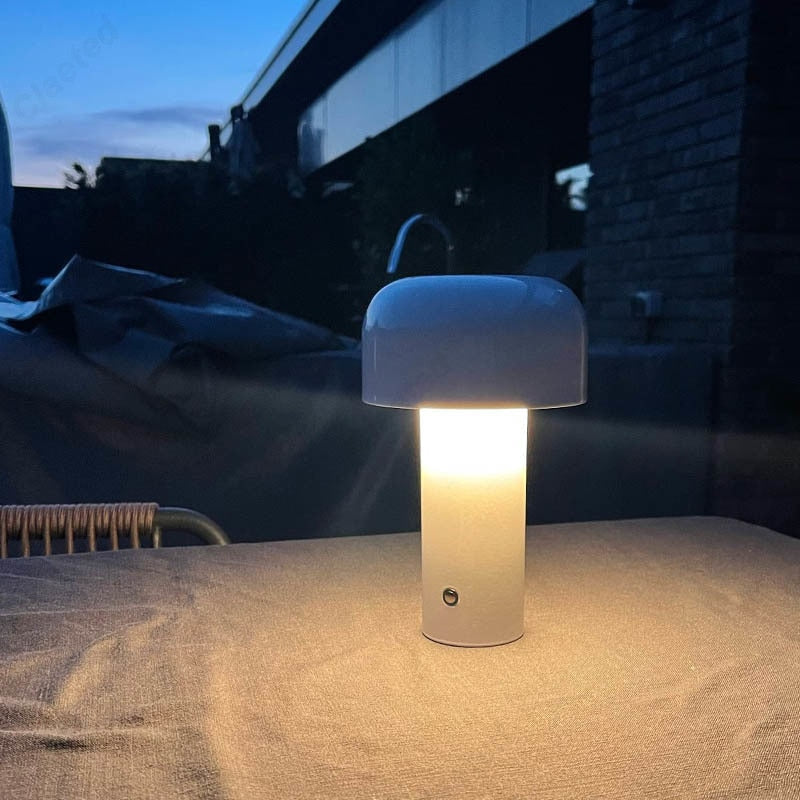 White outdoor lamp on a table with a dark background