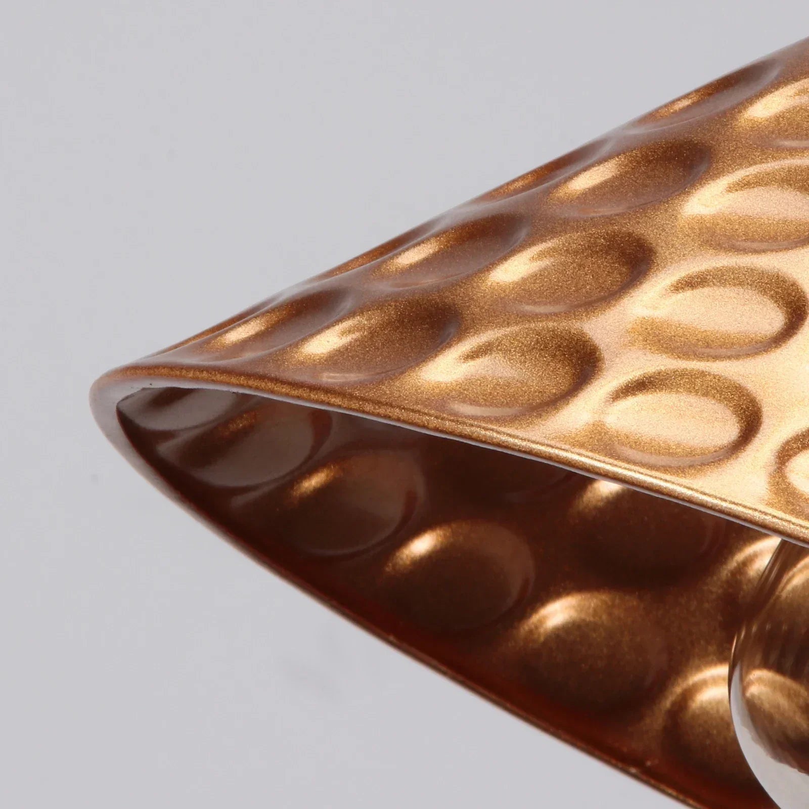 Close-up of a textured brown surface with circular patterns on a light gray background