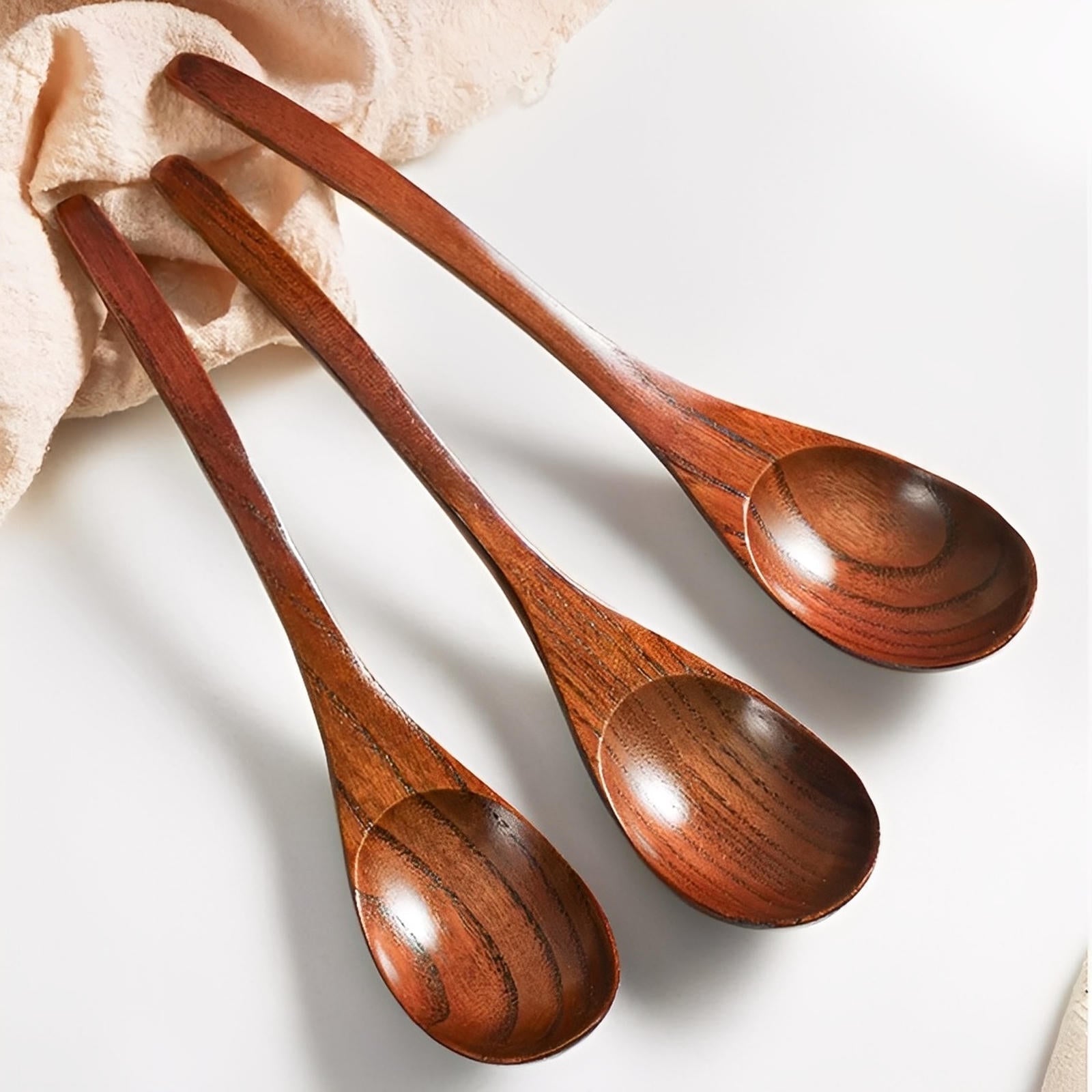 Three wooden spoons on a light background