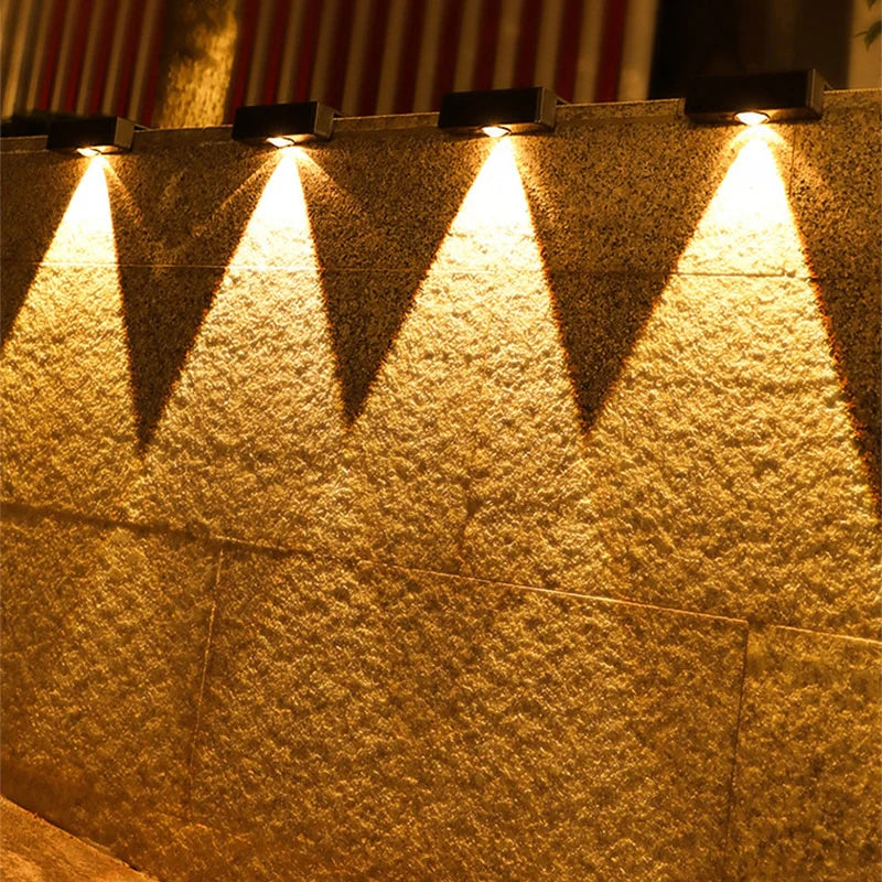 Solar-powered outdoor lights on a wall