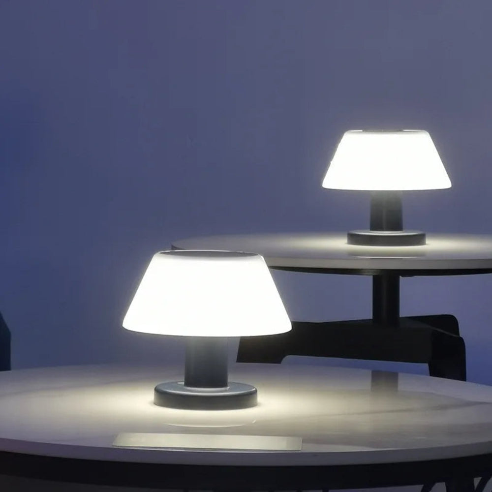 Two table lamps on round tables against a dark background