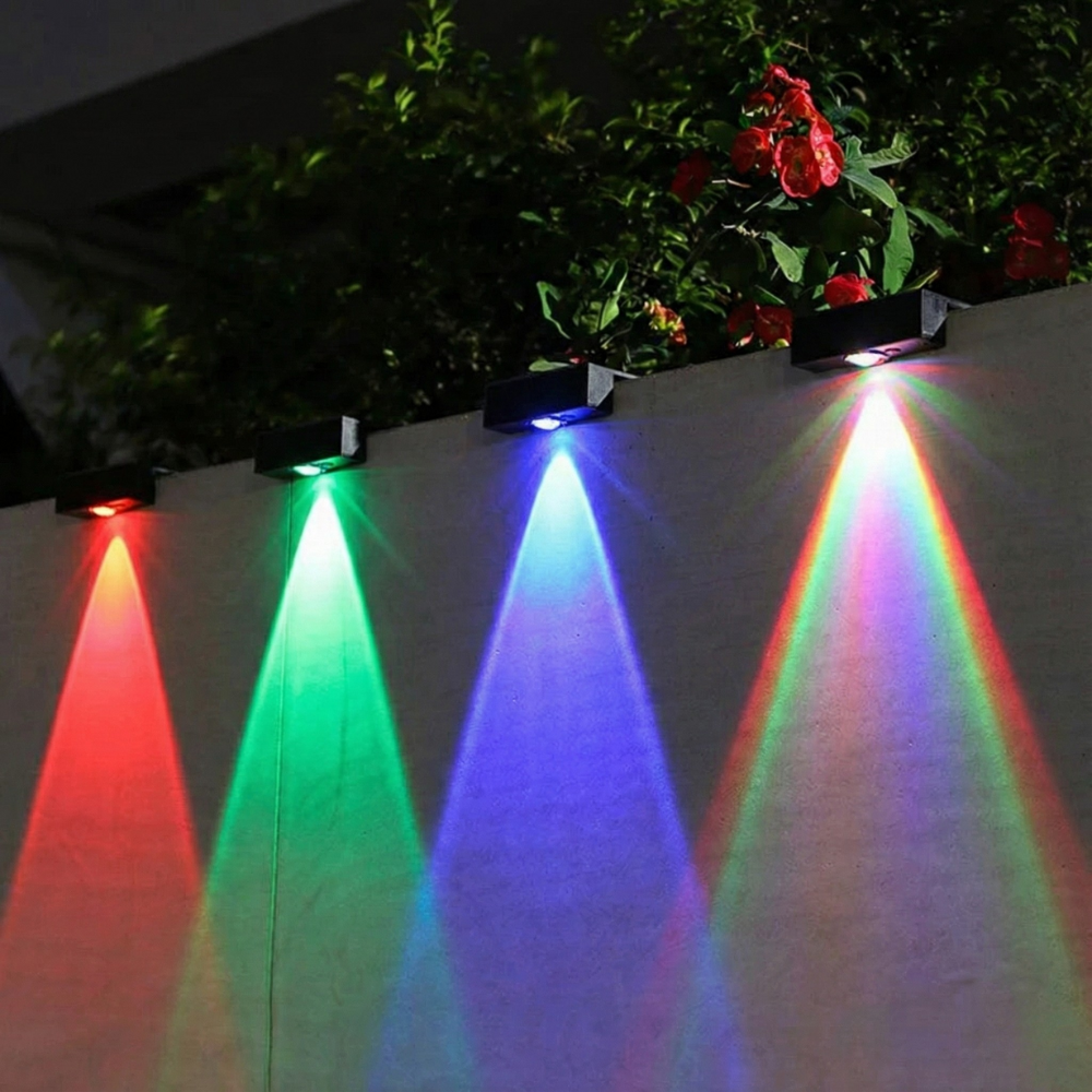 Solar-powered outdoor lights on a wall with plants in the background