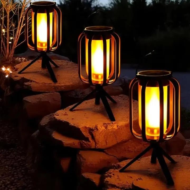 Three illuminated lanterns on a stone surface at night