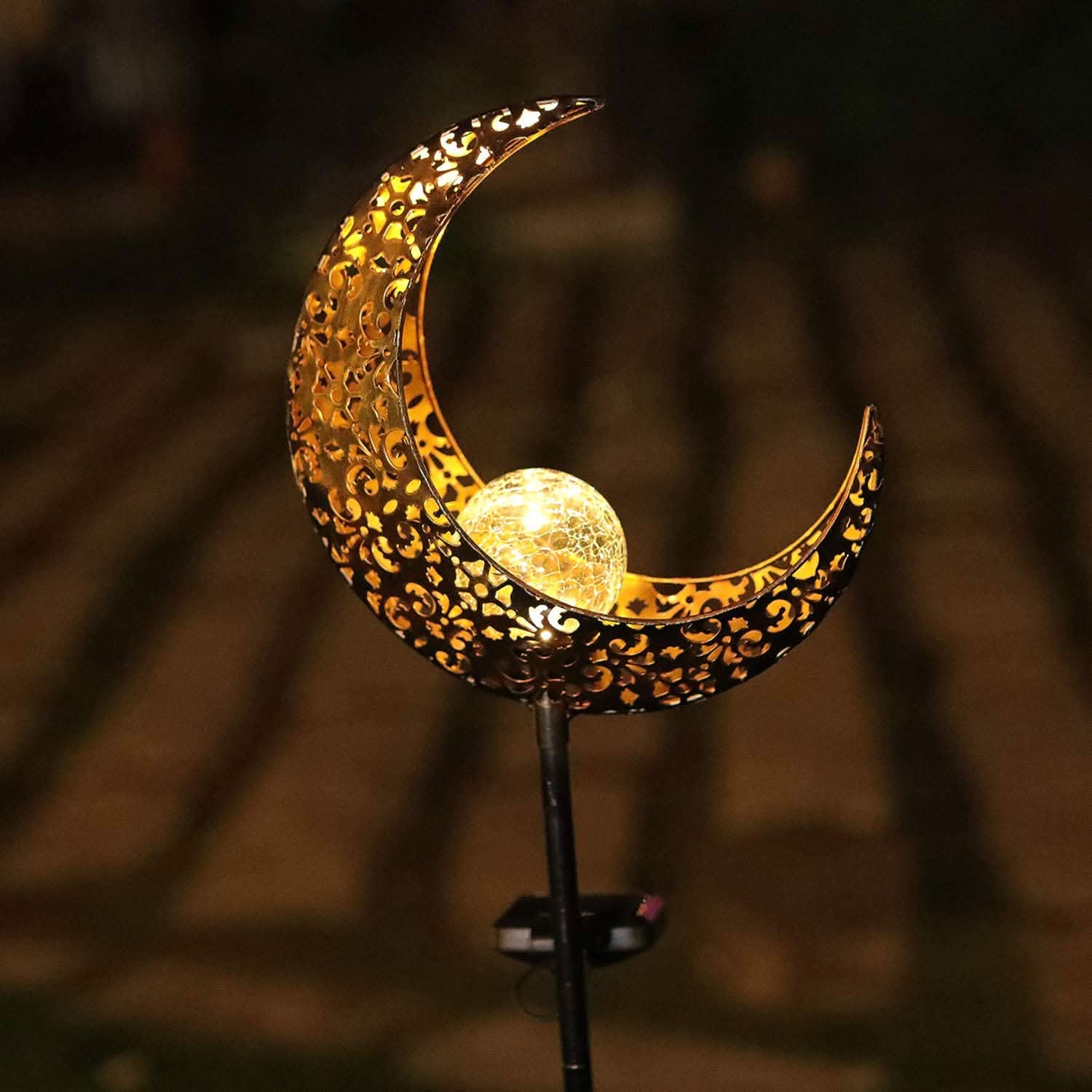 Decorative moon-shaped lamp with a warm glow on a blurred background