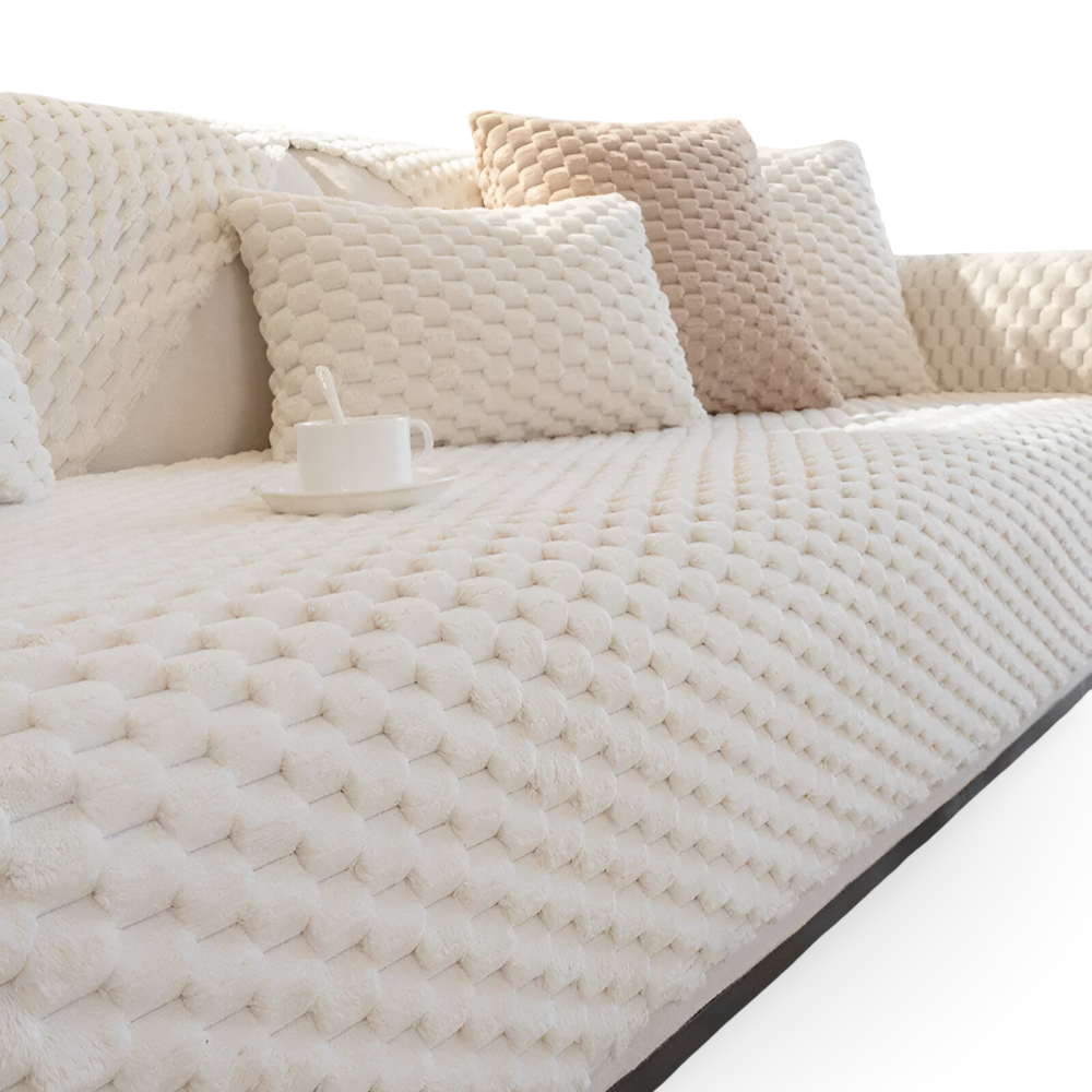 Beige textured sofa with cushions on a white background