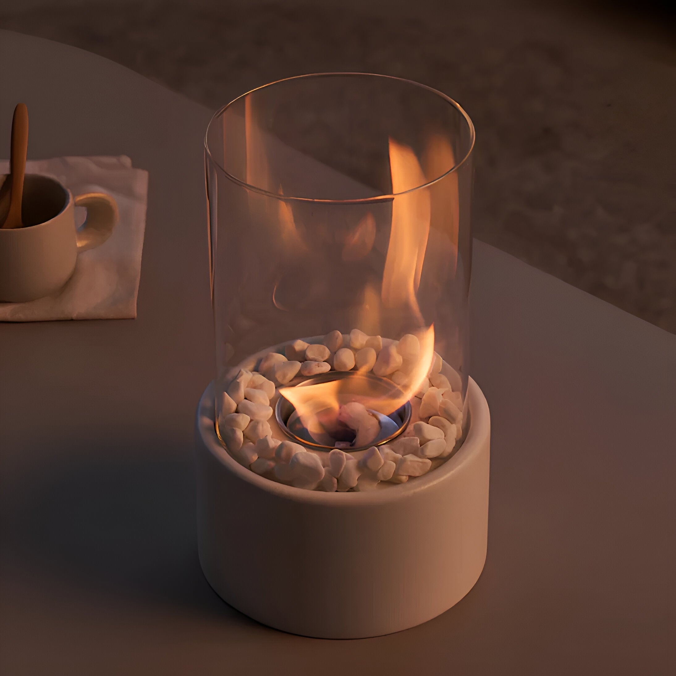 Small table top fireplace with glass cover on a dark surface