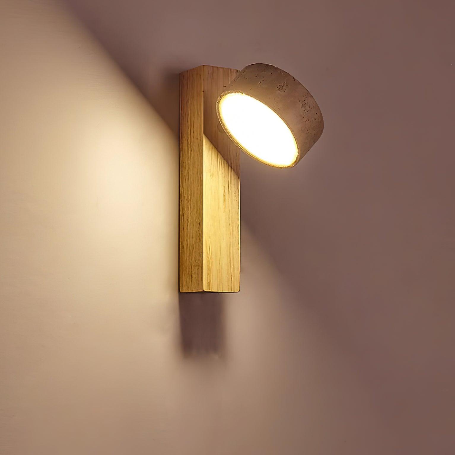 Modern wall light fixture with wooden finish and concrete cover on a neutral background