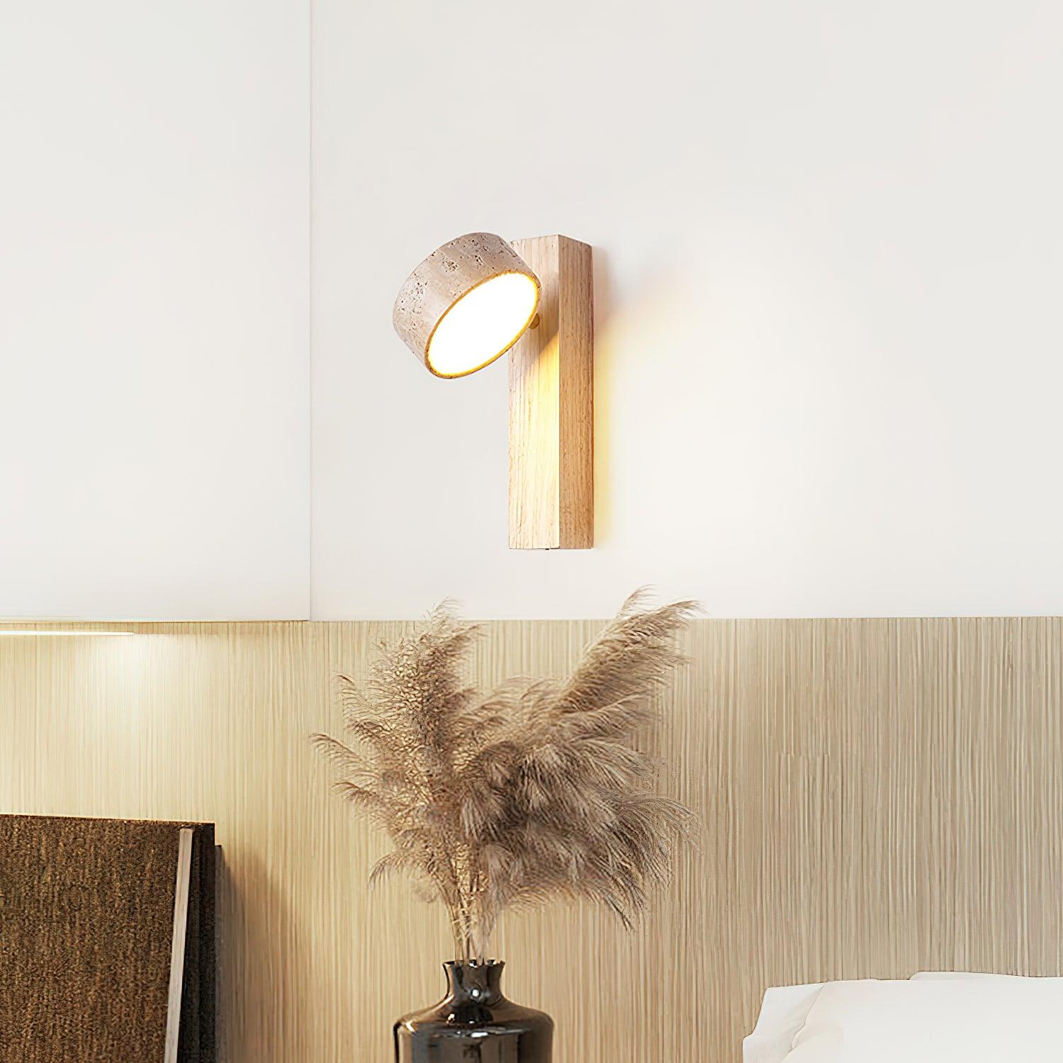 Modern wall-mounted light fixture on a wall with decorative elements.