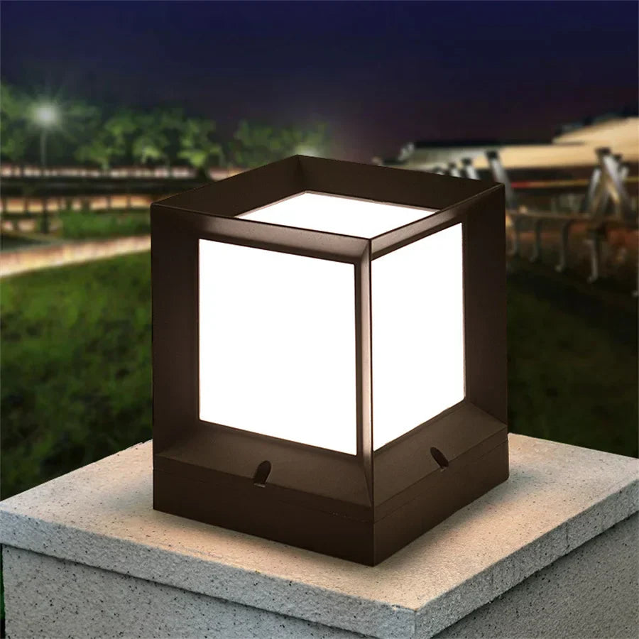 Square outdoor light fixture on a concrete surface at night