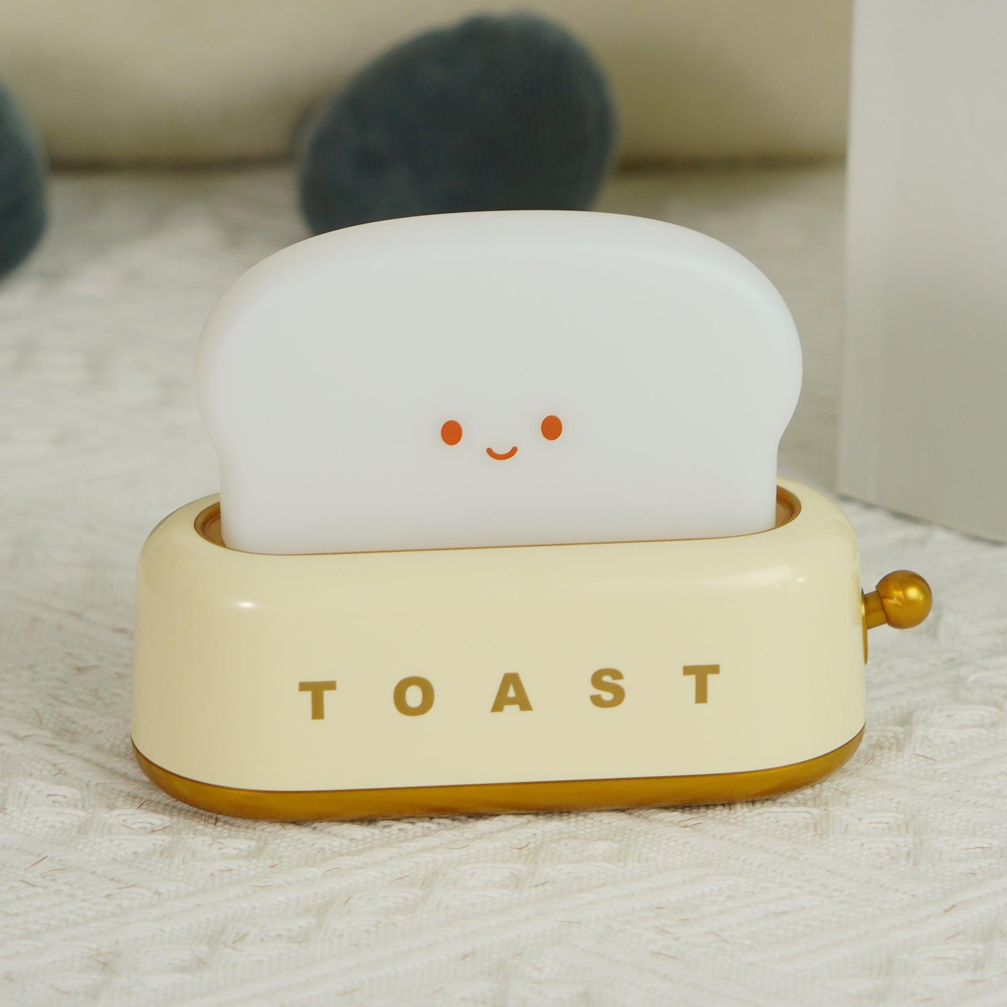Small toy resembling a piece of toast with a smiling face on a white surface.