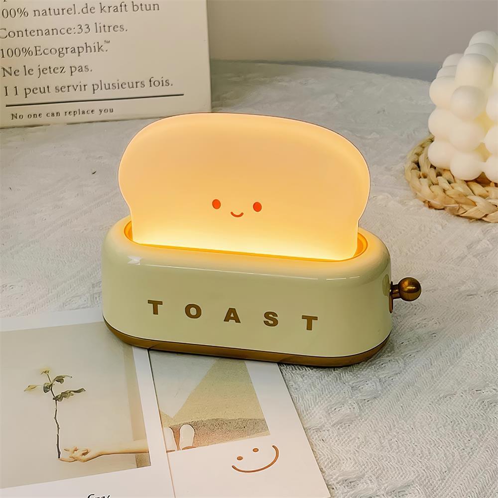 Toy toaster with a smiling face on a surface