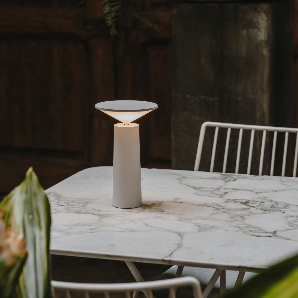 White lamp on a marble table with a blurred background