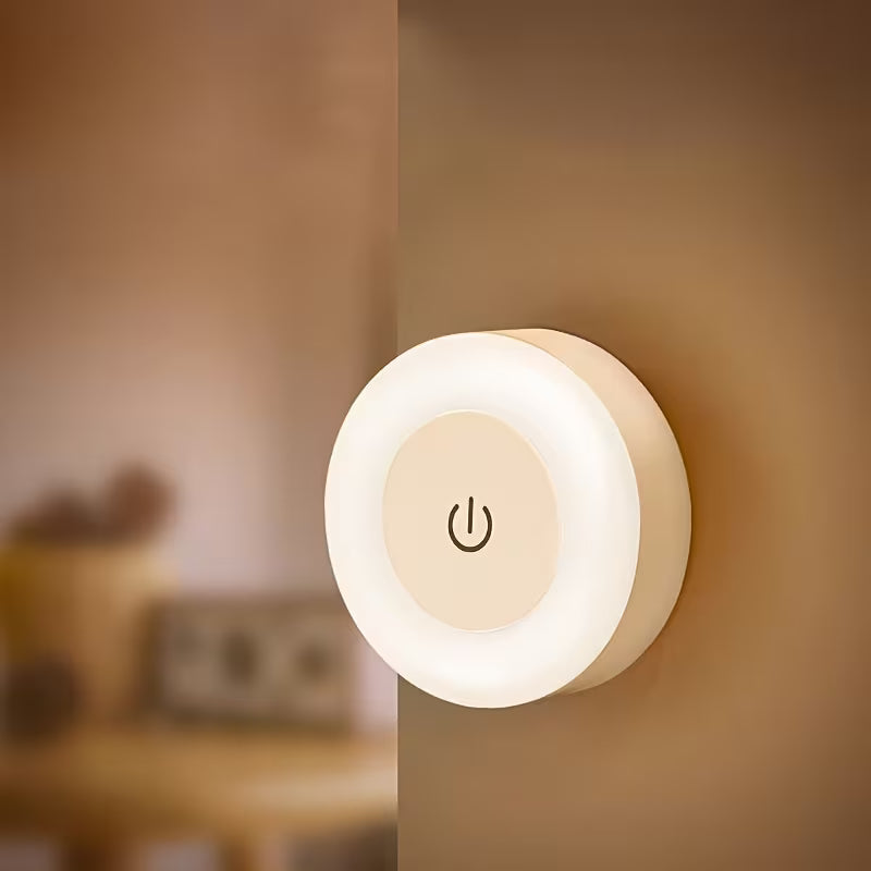 Round night light with power symbol on a wall
