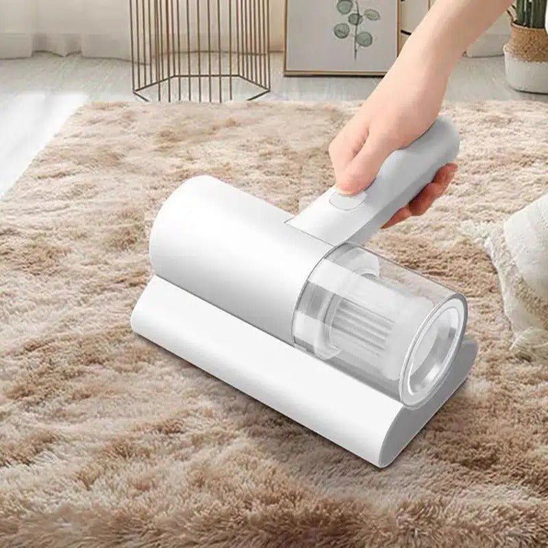 Hand using a handheld vacuum cleaner on a carpet