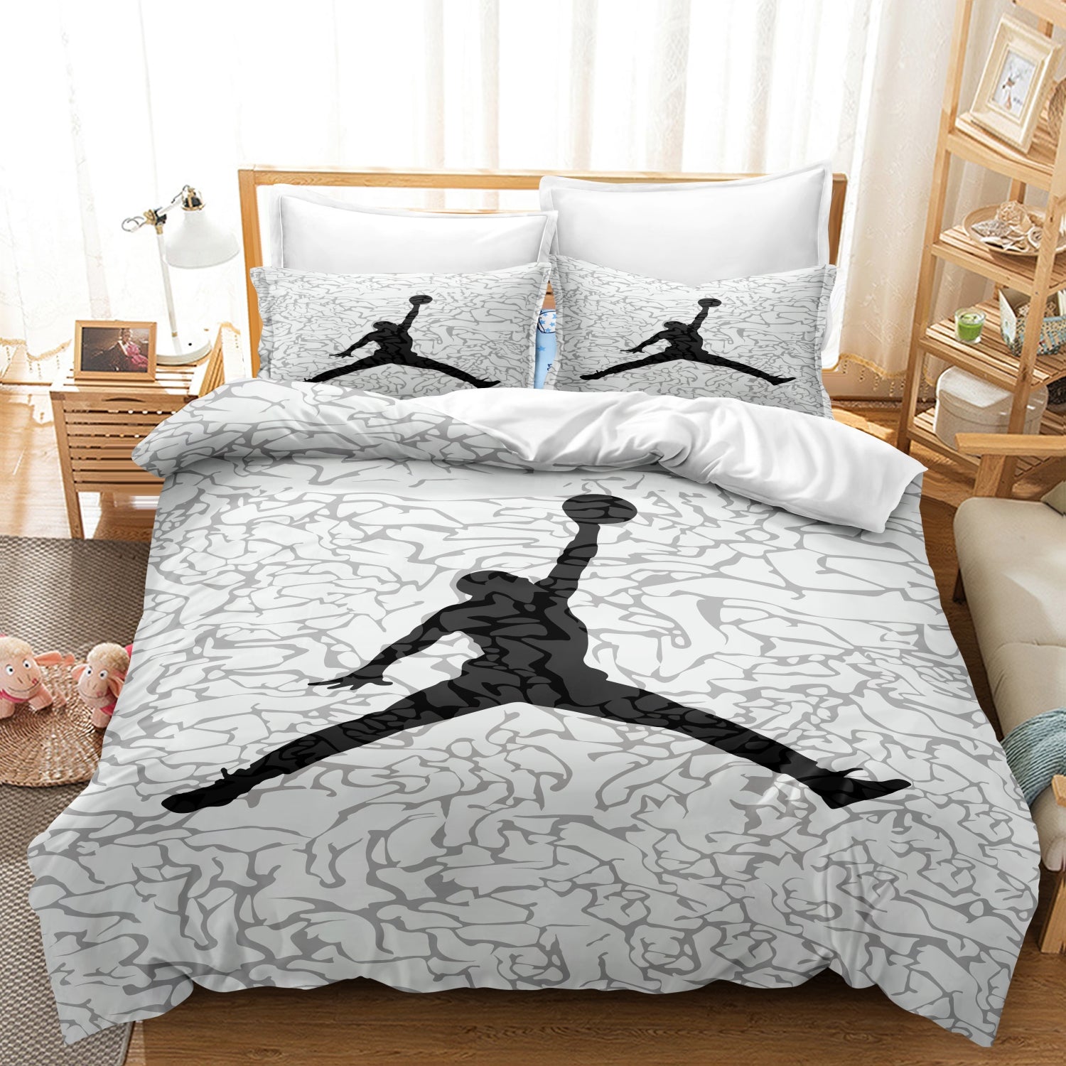 Bedding set with Jordan logo on a bed in a bedroom setting