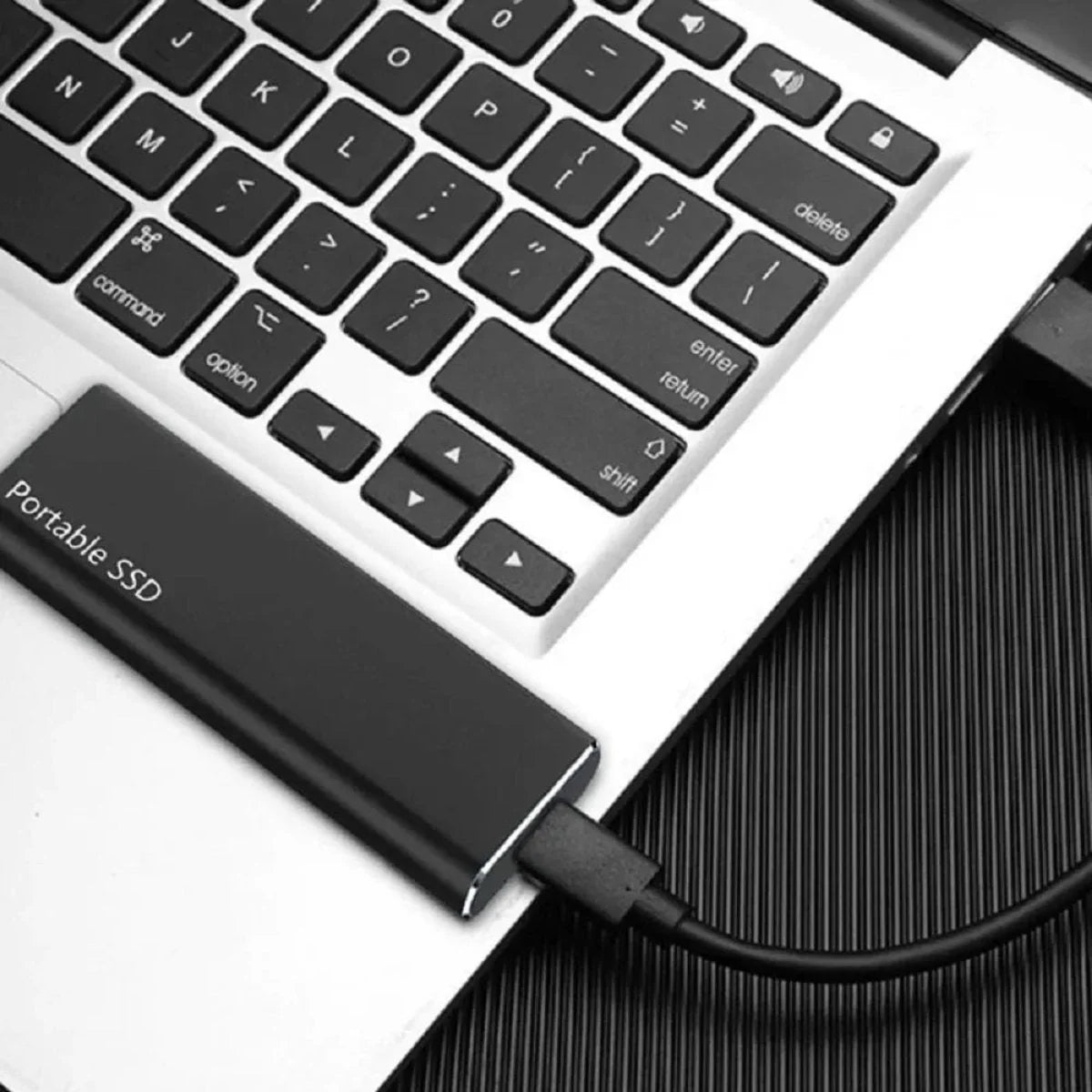 Portable SSD attached to a laptop keyboard
