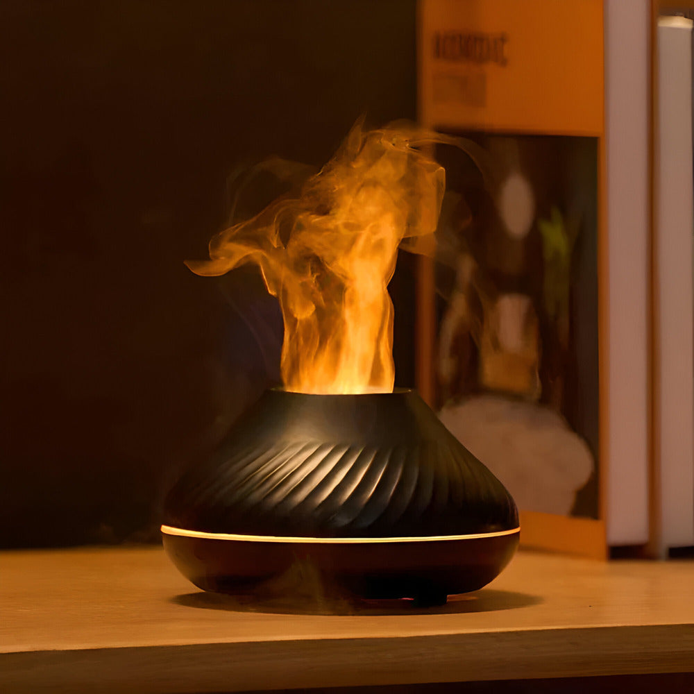 Black essential oil diffuser with steam on a wooden surface