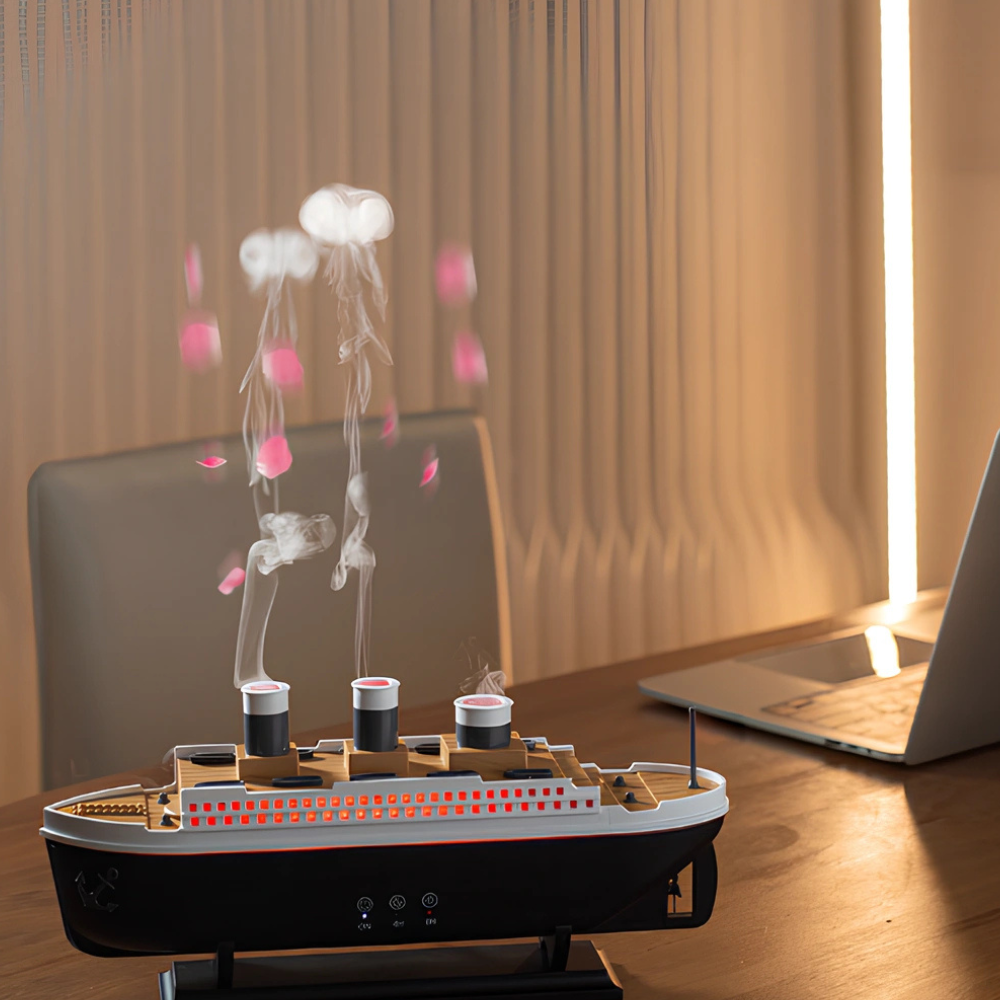 Model ship with smoke effect on a desk next to a laptop