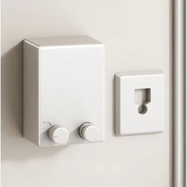 White wall-mounted control panel with two knobs on a light gray wall.