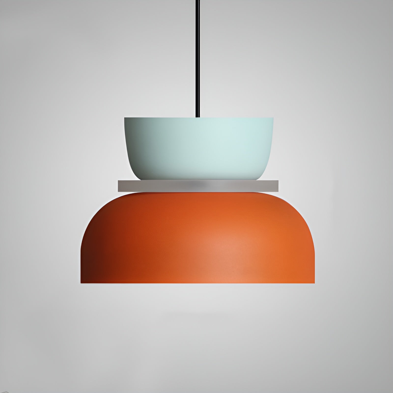 Pendant light with a turquoise top shade and orange bottom shade on a gray background