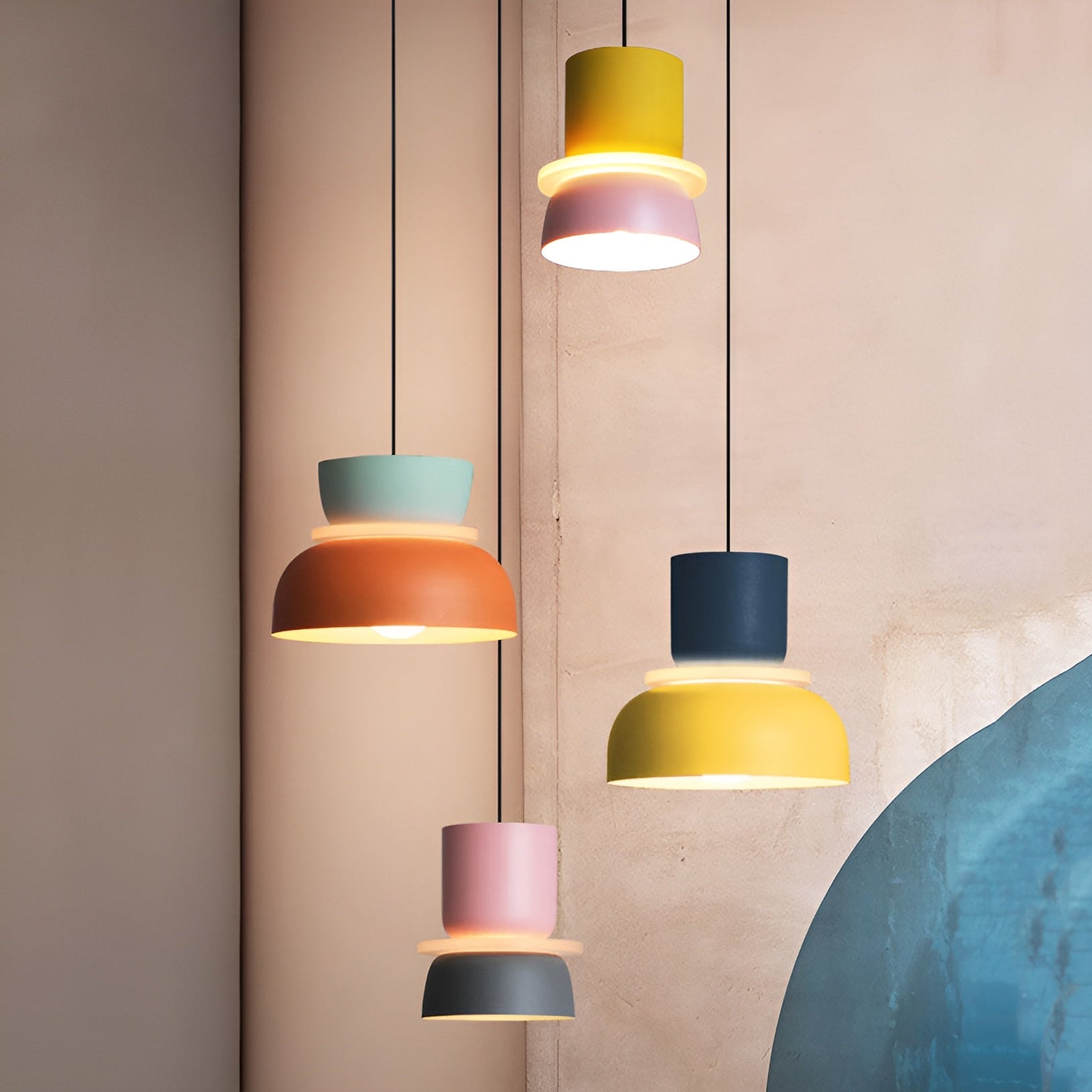 Colorful pendant lights hanging against a neutral wall.
