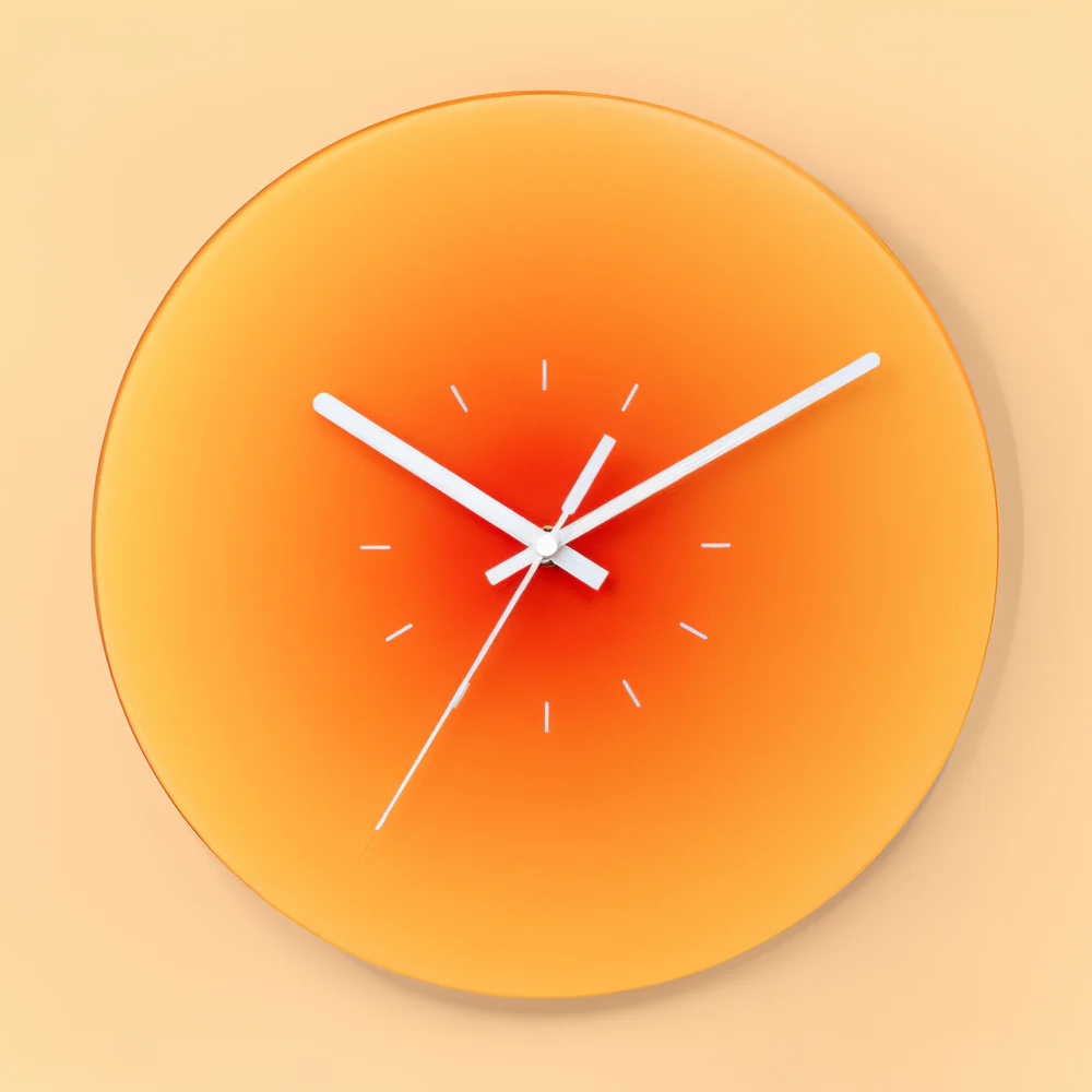 Orange gradient wall clock with white hands on a beige background