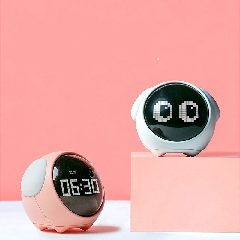 Two round digital clocks, one pink and one white, on a pink background.