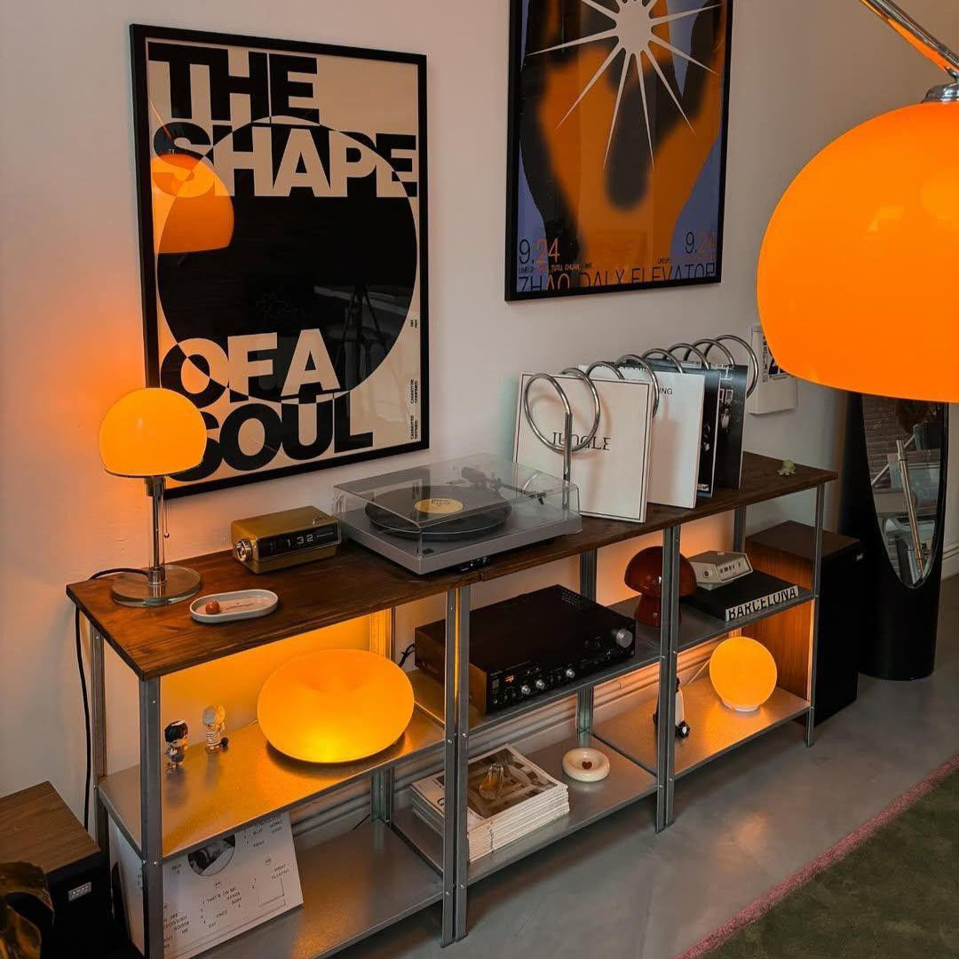 Modern interior with a shelf, floor lamp, and wall art in a room.