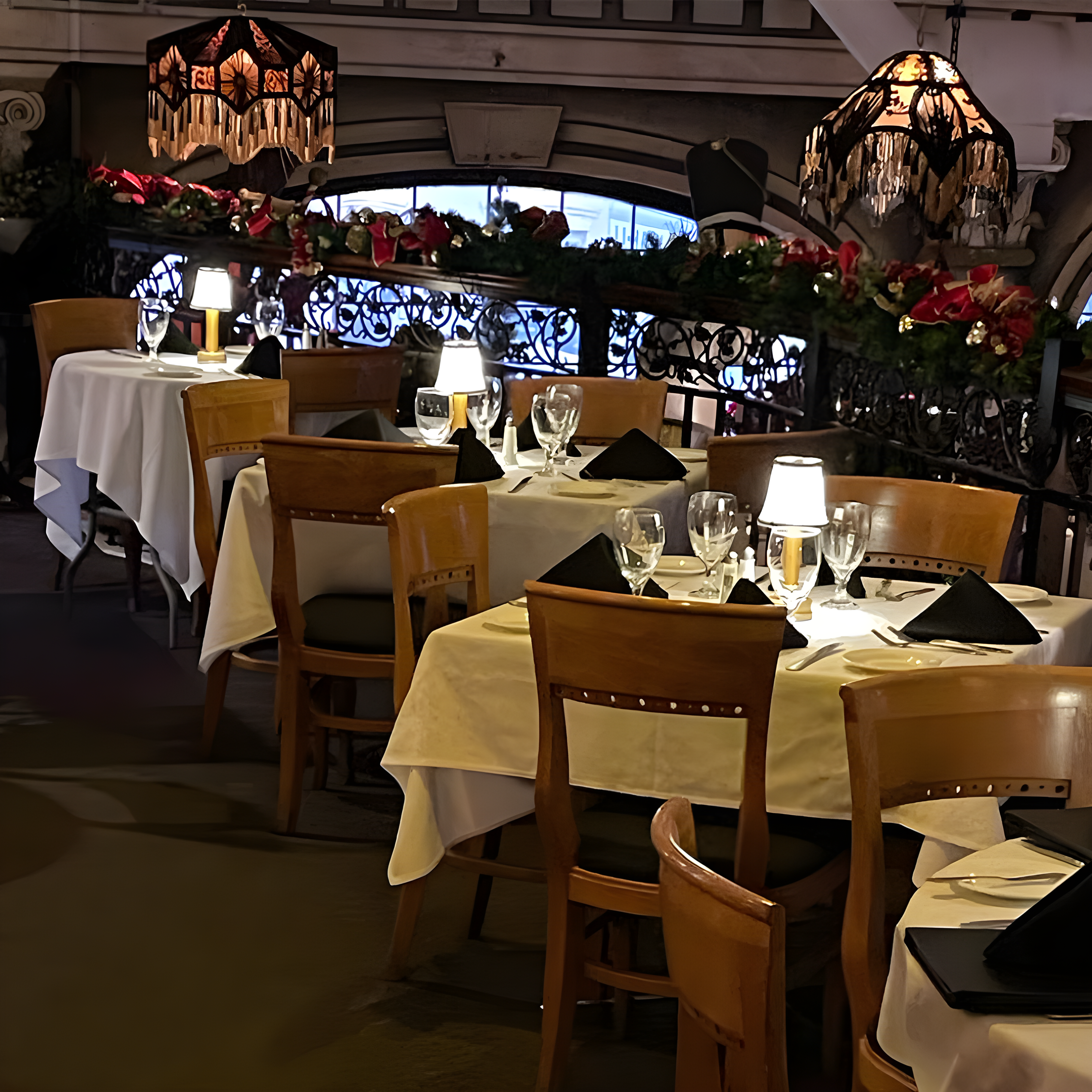 Dining area with tables set for meals, chairs, and decorative elements in a restaurant.
