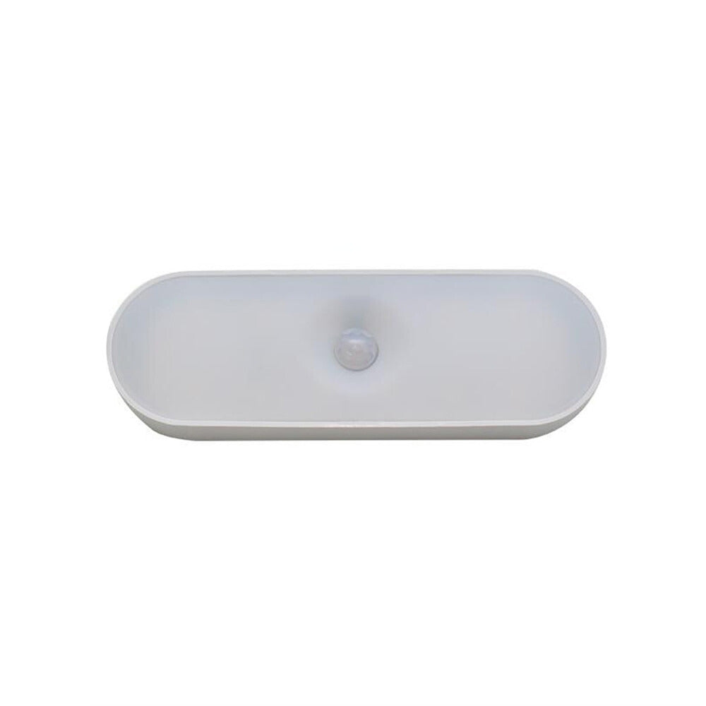 White oval-shaped motion sensor on a white background