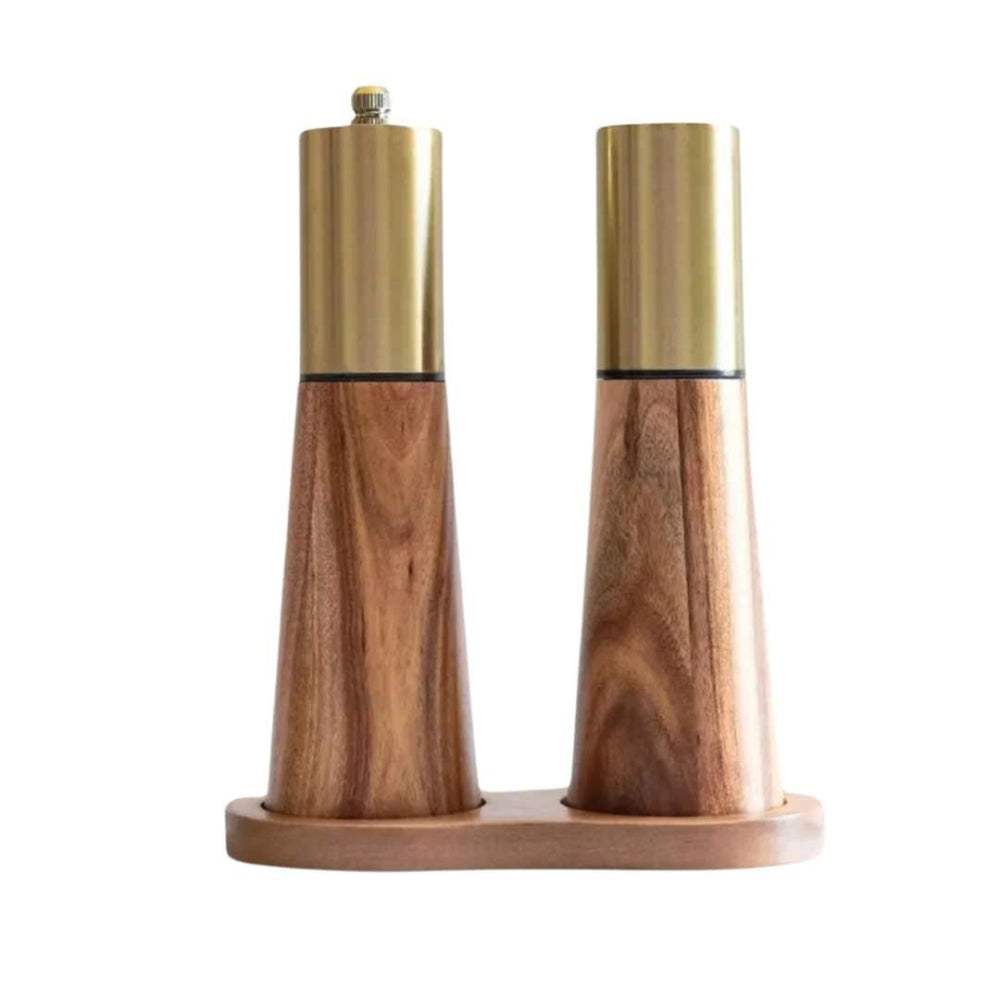 Wooden salt and pepper shakers with gold tops on a white background