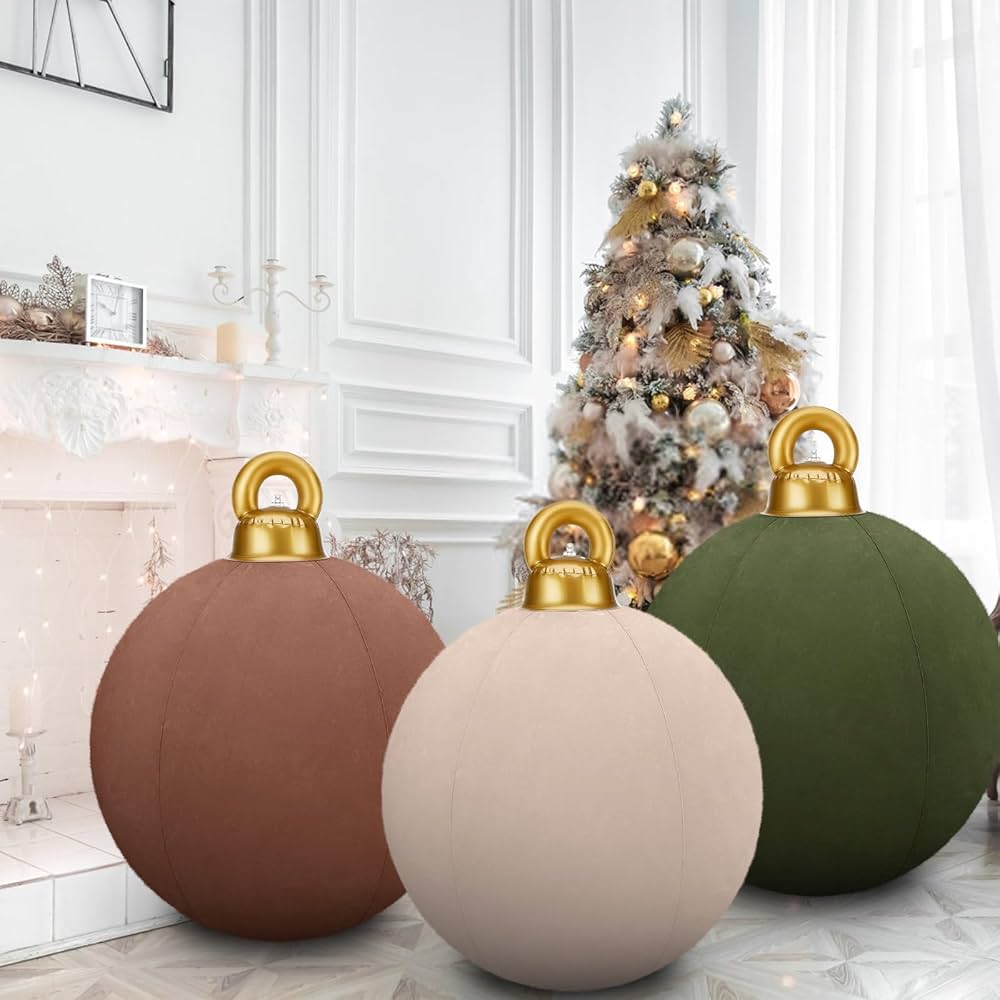 Three decorative ornaments with gold tops in front of a Christmas tree.