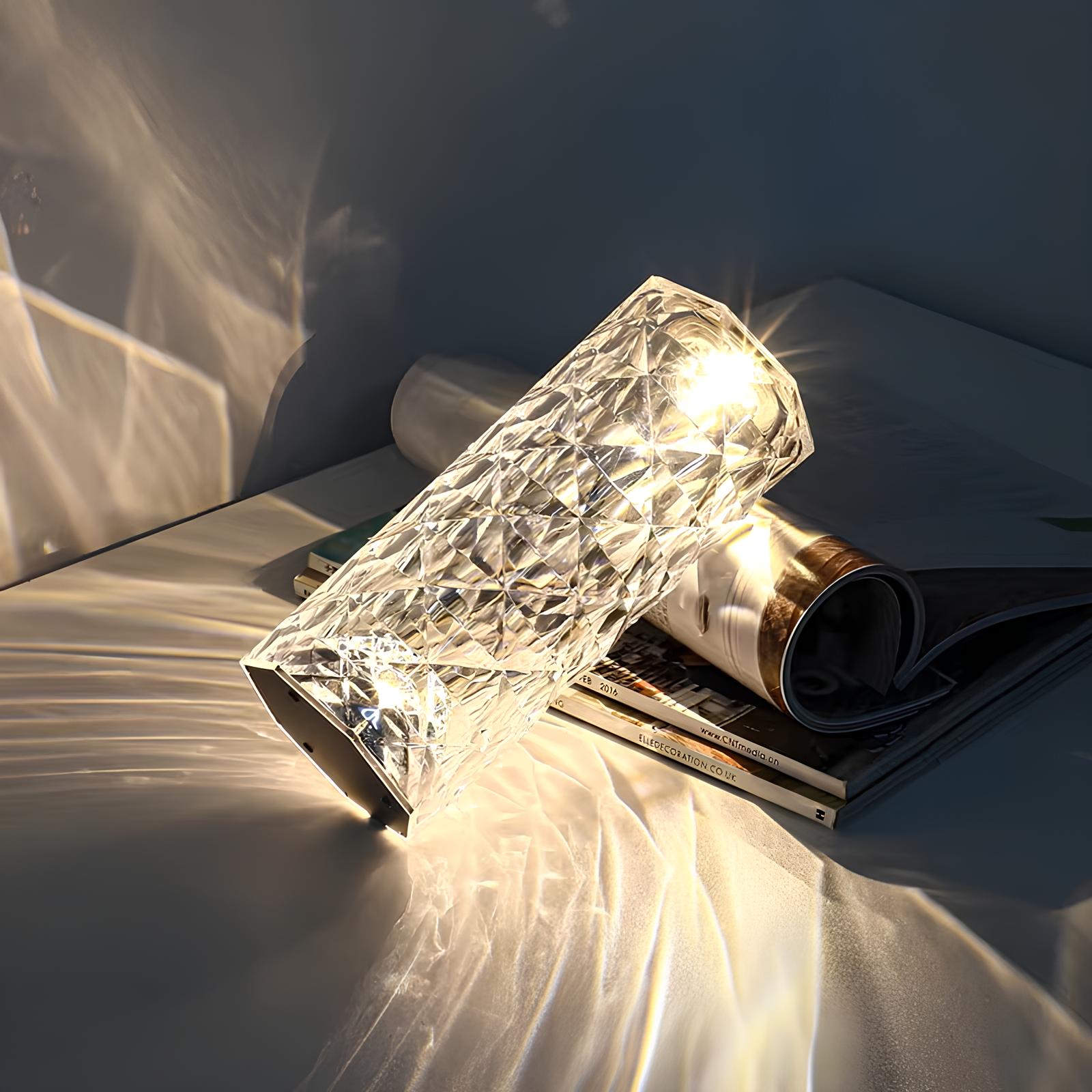 Crystal wall sconce emitting warm light on a textured surface