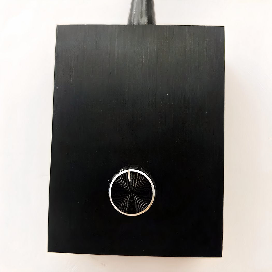 Black square object with a circular design on a white background
