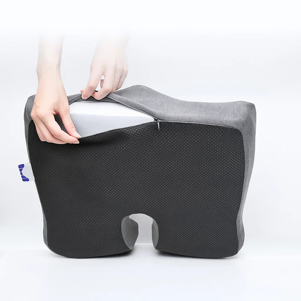 Cushion with a person's hand holding it on a white background