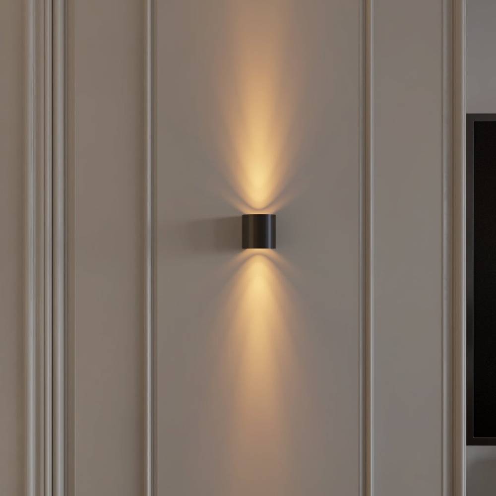 Wall-mounted light fixture casting a warm glow on a neutral wall.