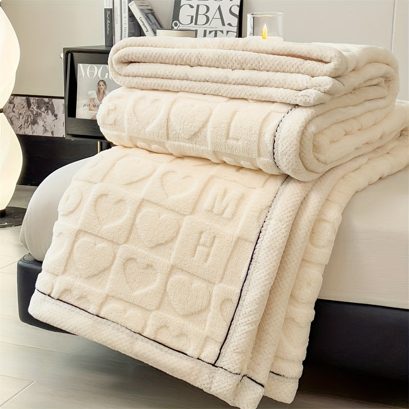 Beige textured blanket draped over a sofa with decorative elements in the background
